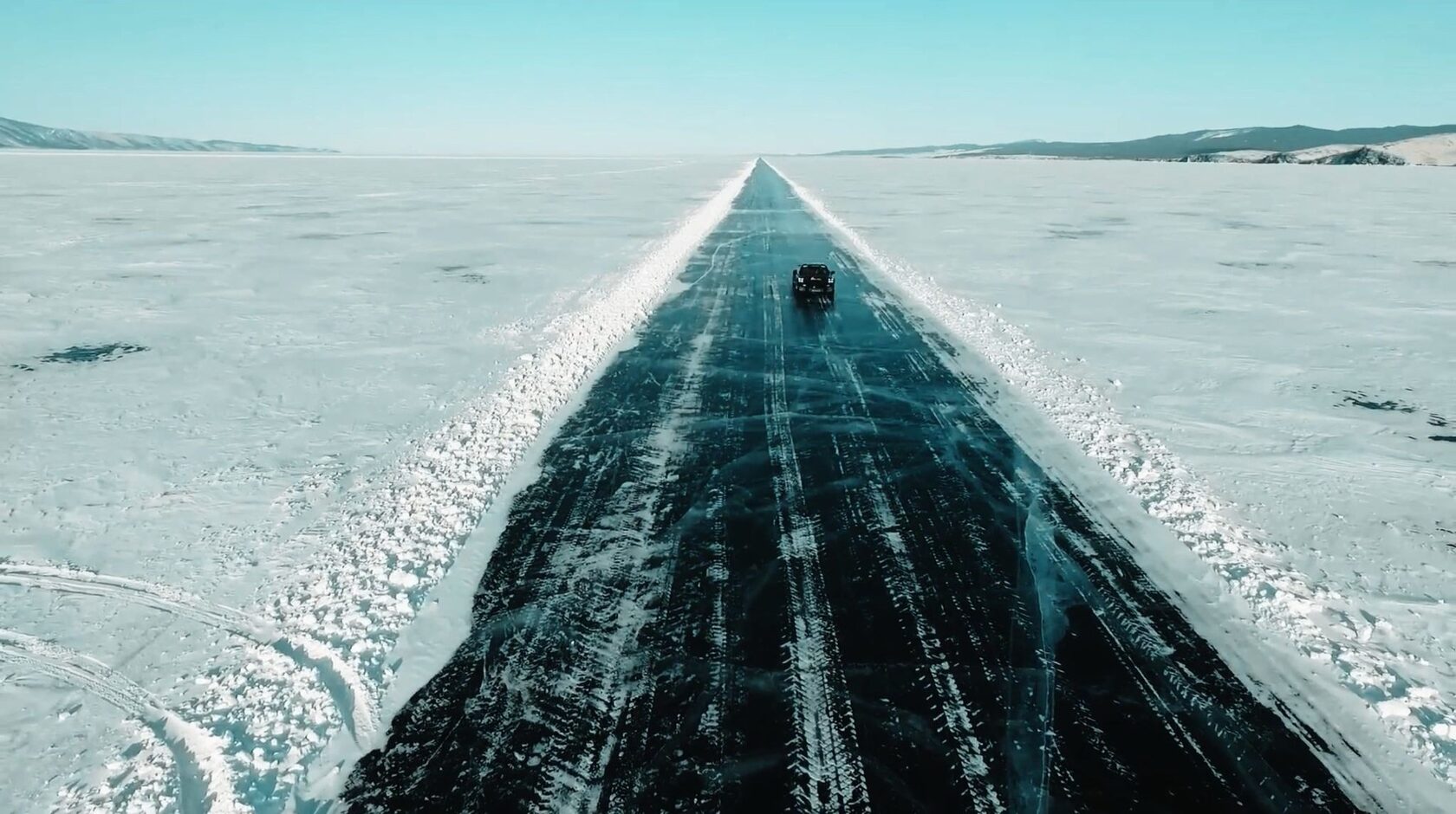 Car on an ice road across Lake Baikal, aerial