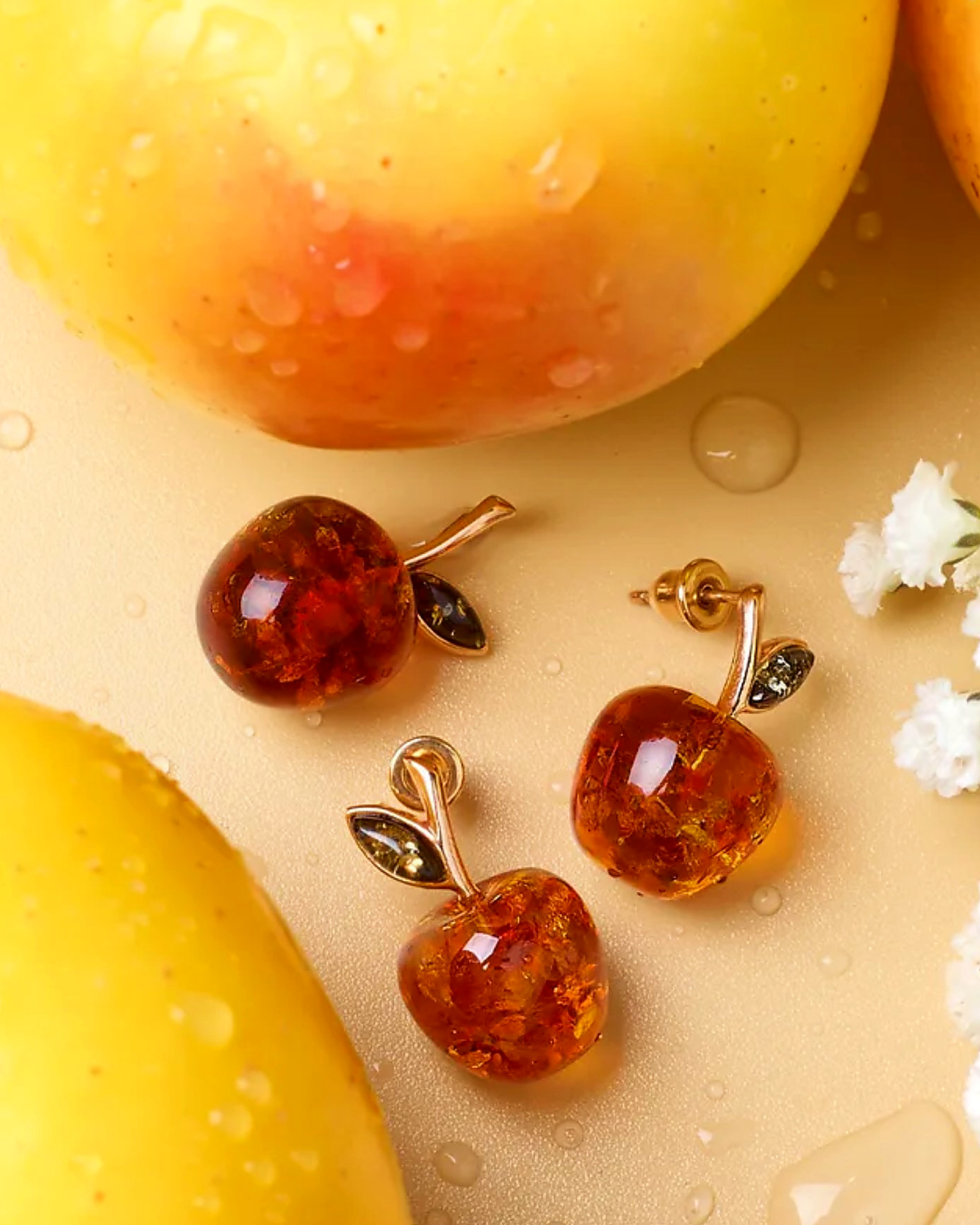 Amber apple pendant and studs on a peach background