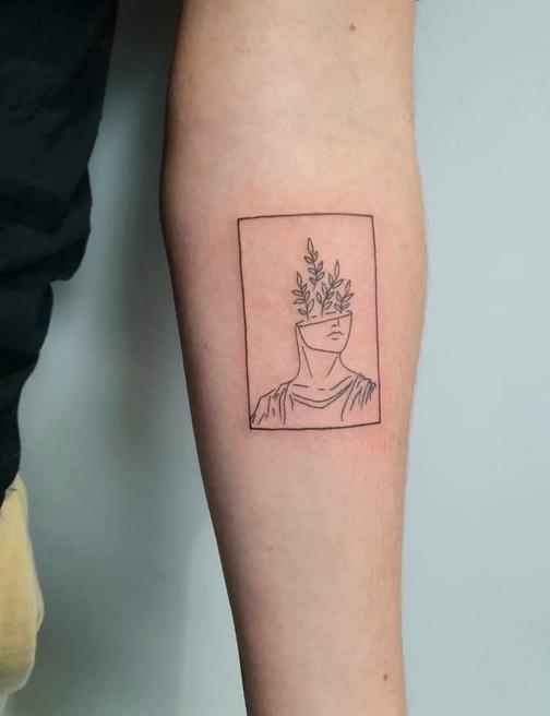 Black and grey creature tattoo on calf