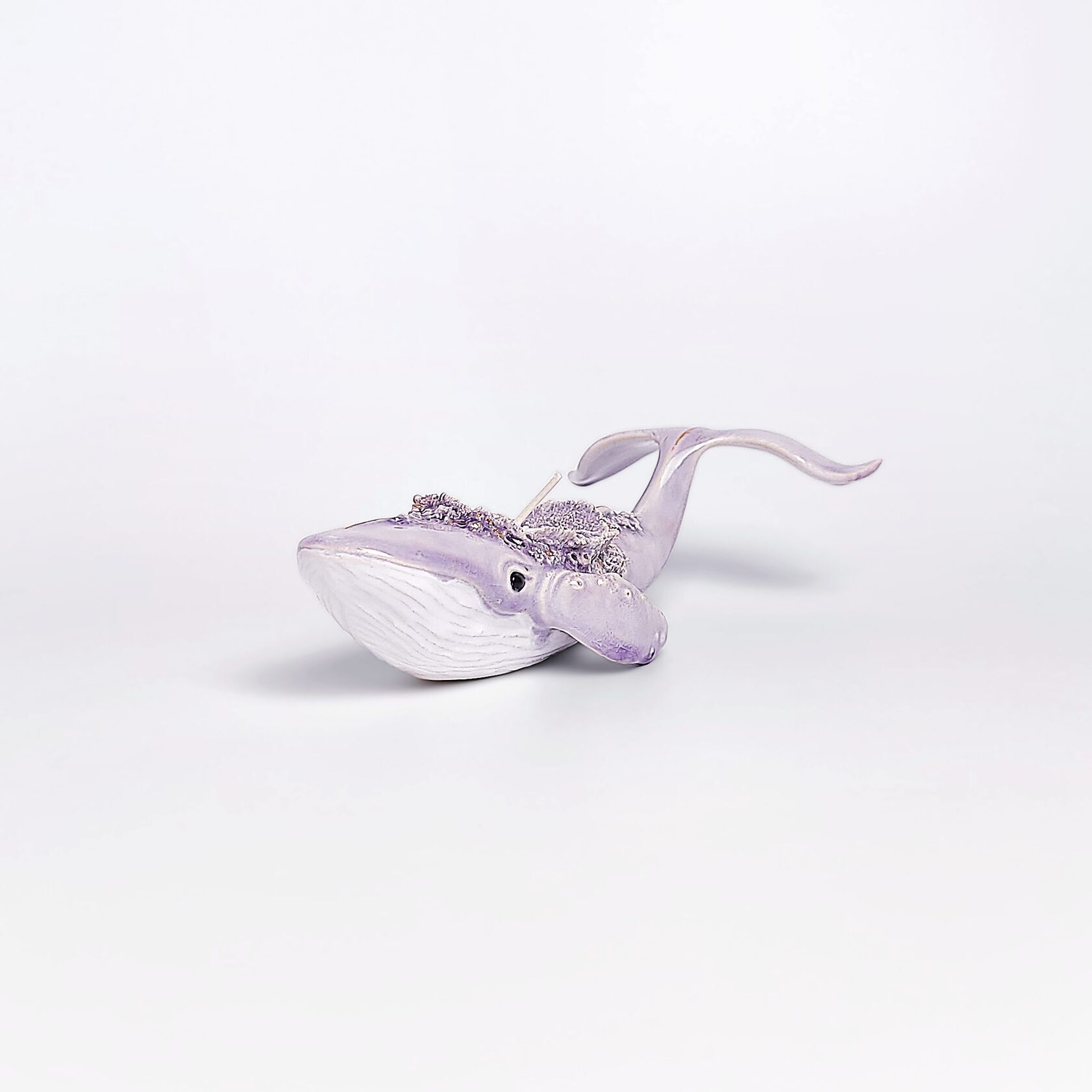 handmade ceramic candle holder shaped like a purple whale with sculptural details