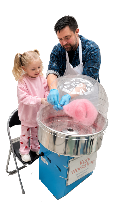 Child learning to make candy floss with the Irish Clouds team