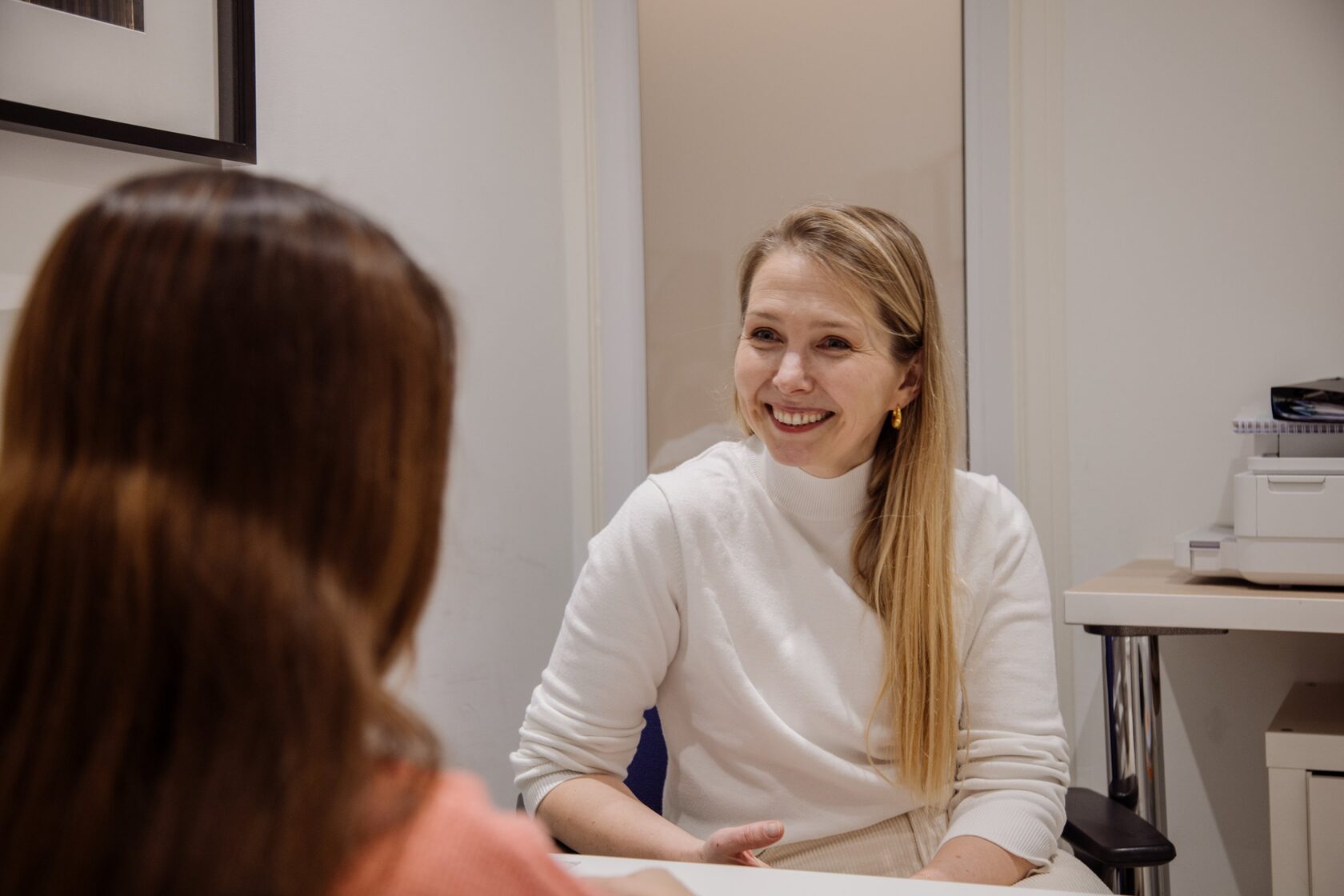 Dr Maria Naymark talking with a patient in her consulting room