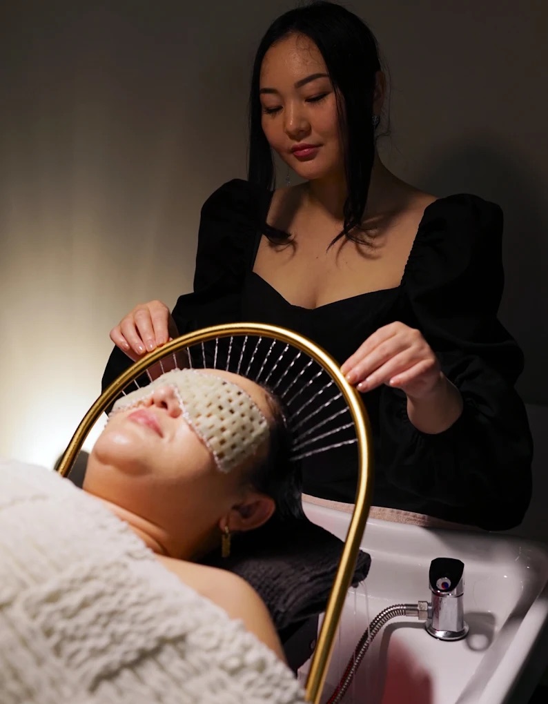 Licensed esthetician performing a Japanese head spa treatment with the Water Halo system at AURA Japanese Head Spa, Ross Park Mall, Pittsburgh