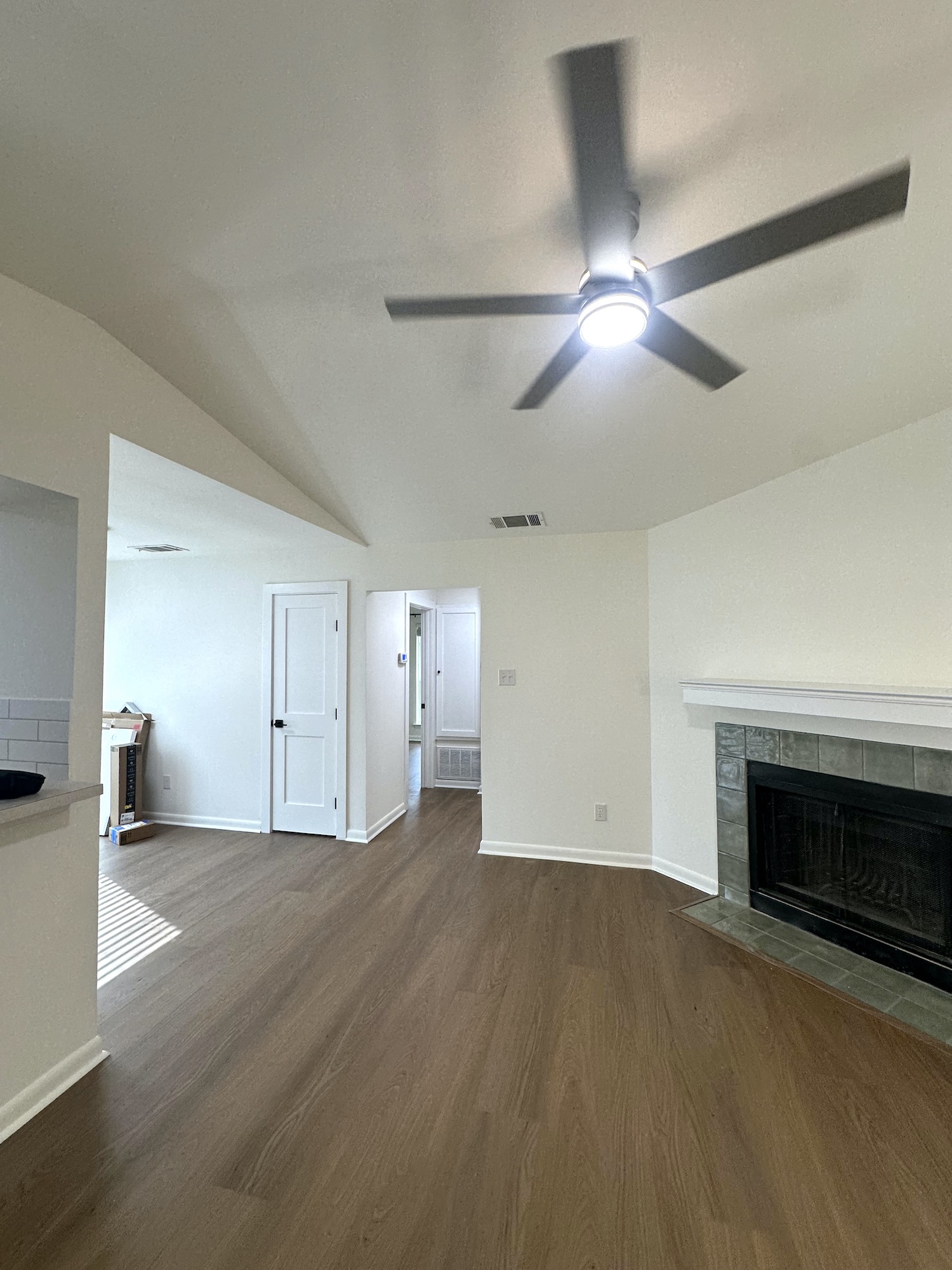 Finished living room with smooth vaulted ceiling, refreshed walls and new flooring