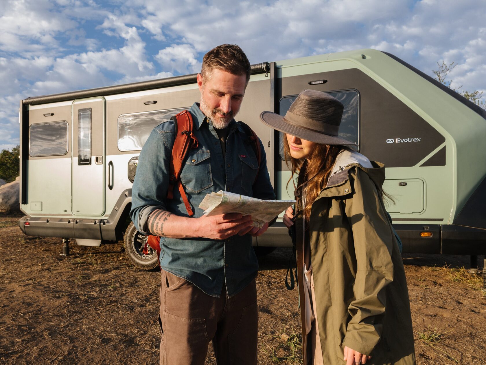 Couple reading a map by the Evotrex trailer