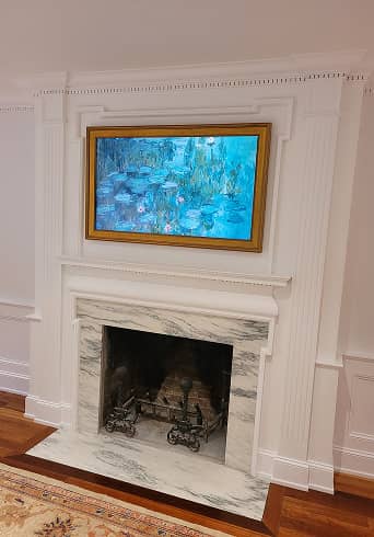 Living room with wainscot paneling and fireplace surround