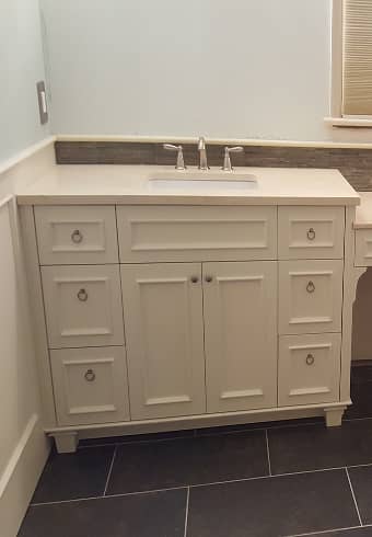 The bathroom vanity with applied moulding to the drawer fronts and doors