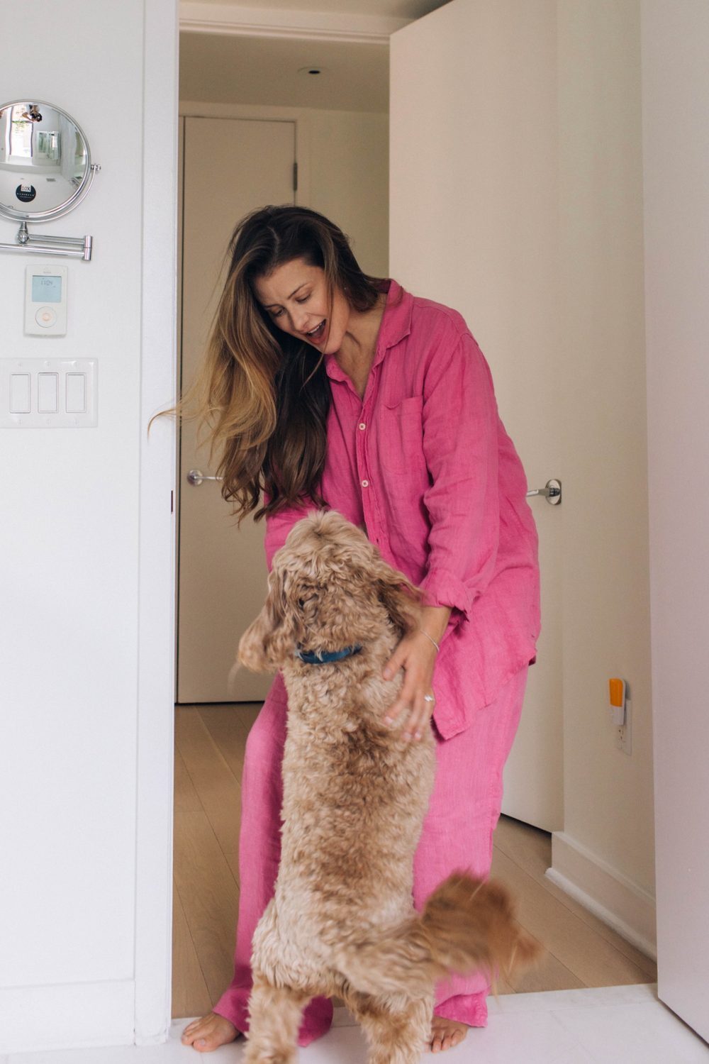 Lo at home greeting her dog