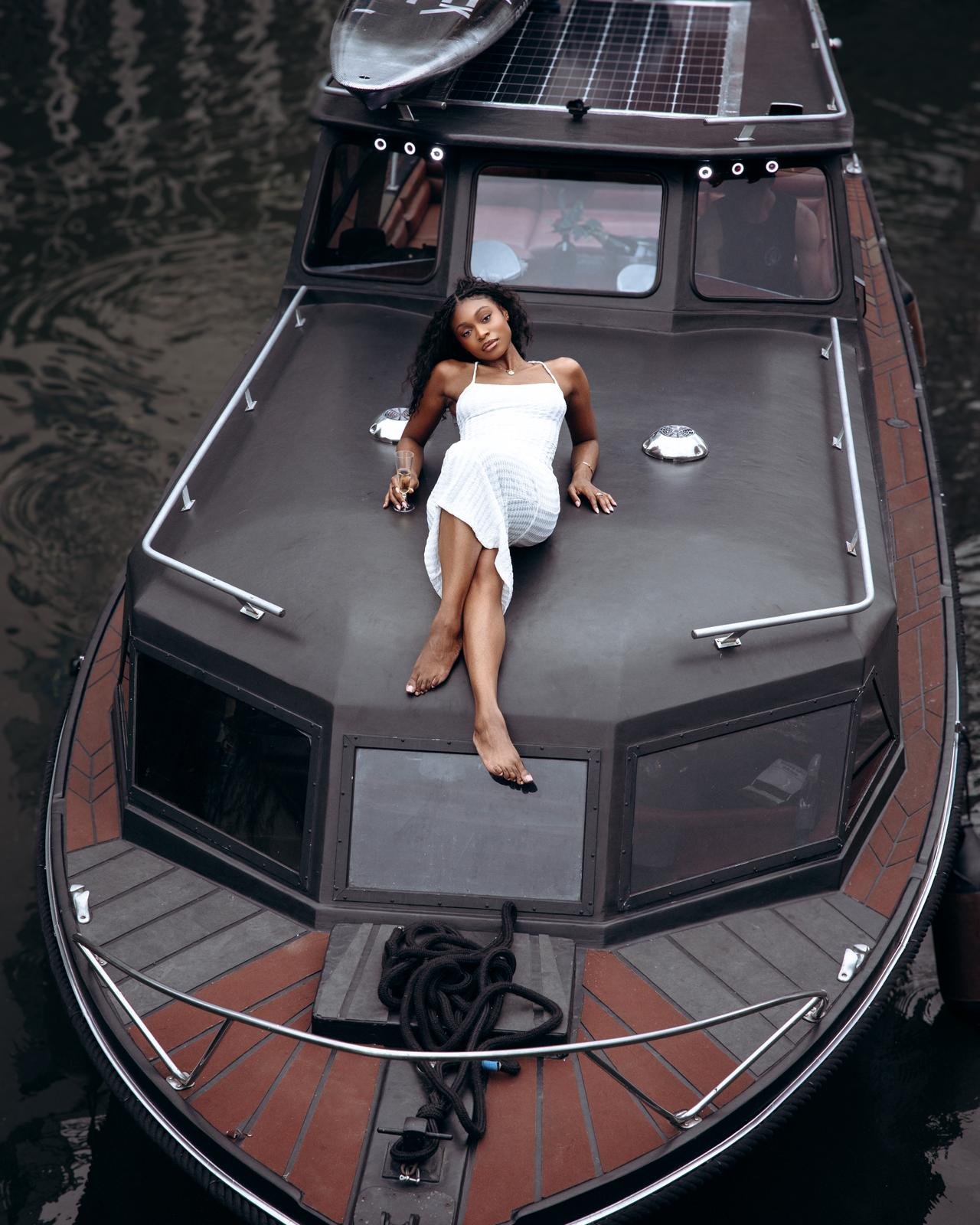 Guest relaxing on Sushi Boom boat roof