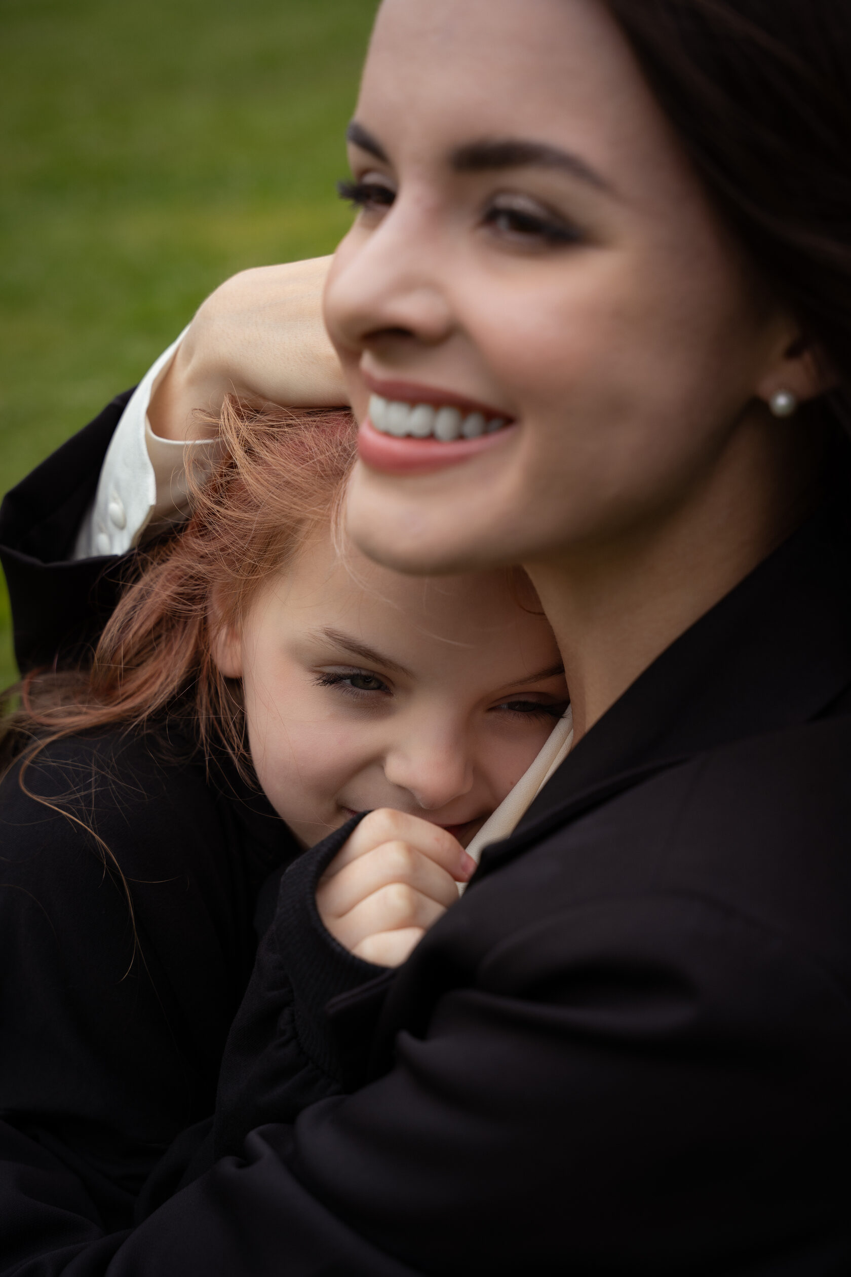 A smiling mother holding her young child close