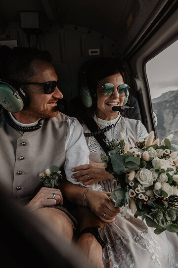 Wedding couple in a helicopter over the Alps — adventurous elopement with mountain views