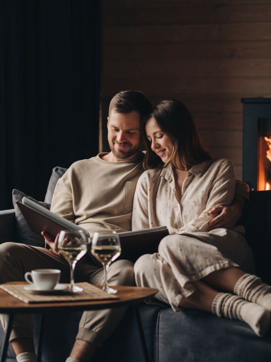 Couple reliving their mountain wedding memories by the fire — cozy and emotional storytelling photography
