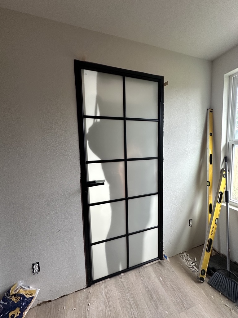 Interior finish detail · Aluminum-frame glass door — Austin house flip by Kir Remodeling