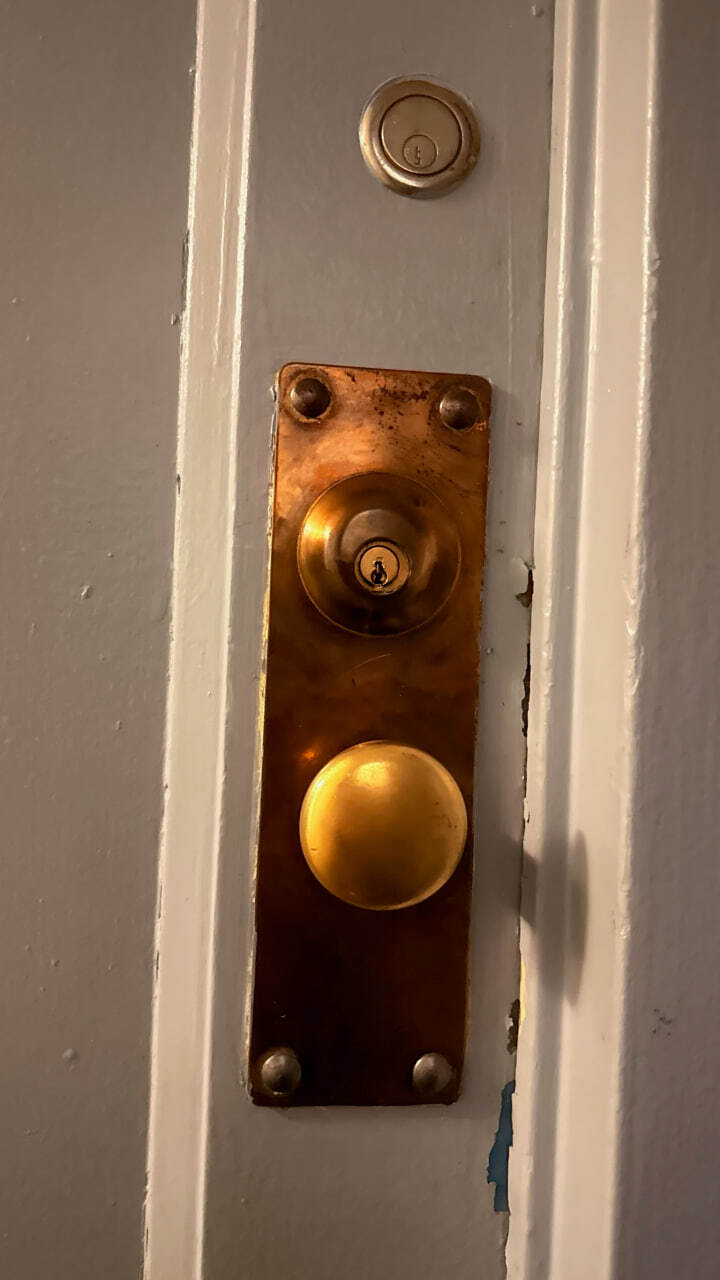Vintage brass lock on an NYC apartment door, serviced by LexKey Locksmith LLC