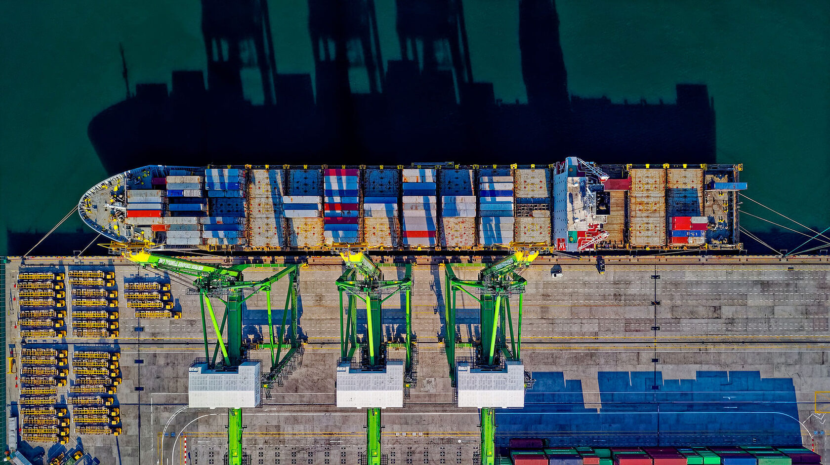 Container ship docked at a busy terminal