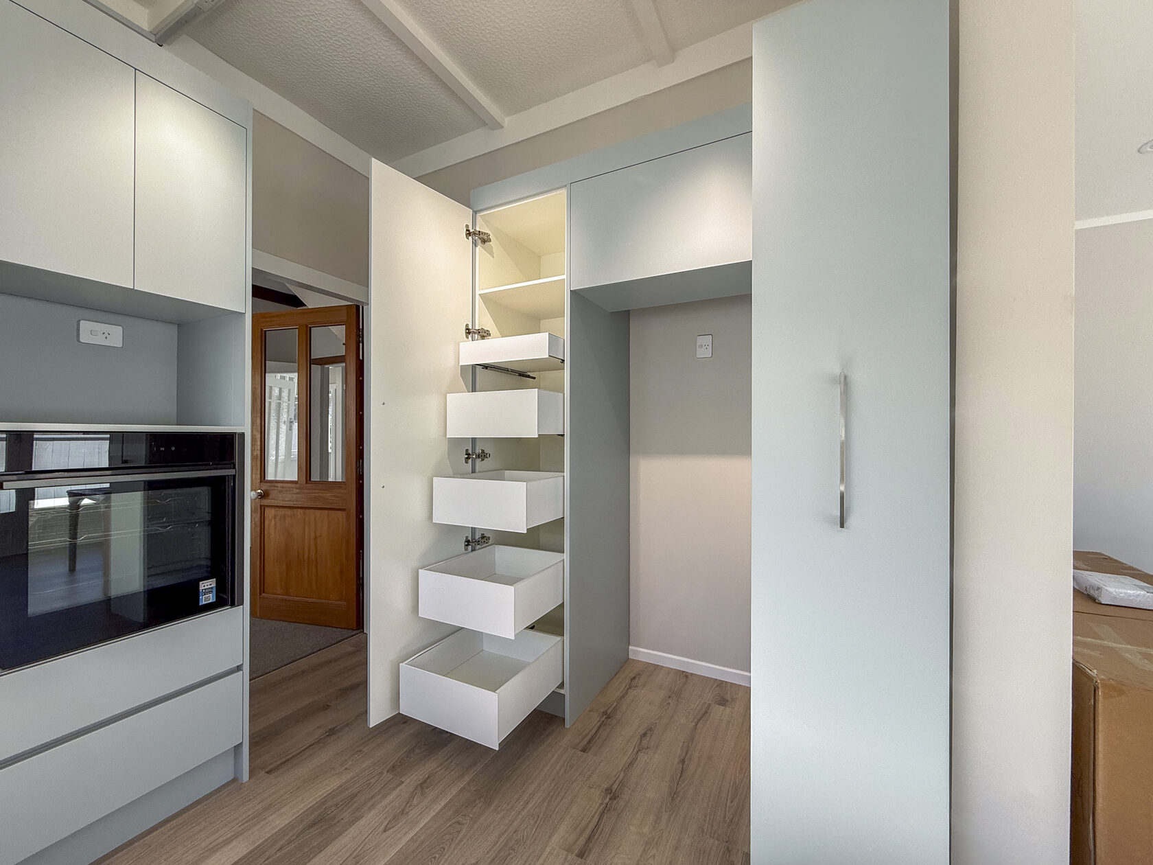 Open pull-out drawers in tall kitchen cabinetry