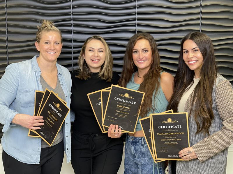 Delta graduates holding their 5 Star Academy certificates