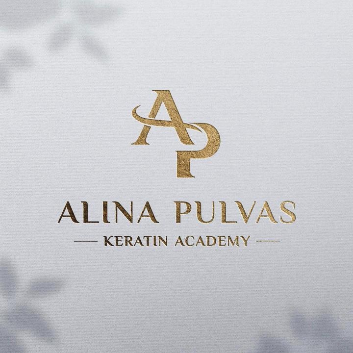 ALINA PULVAS logo in gold foil on paper