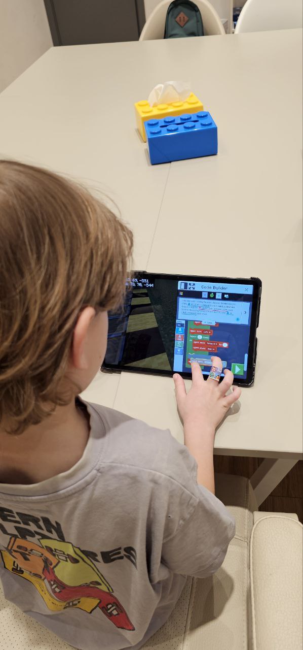 Child learning coding on a tablet