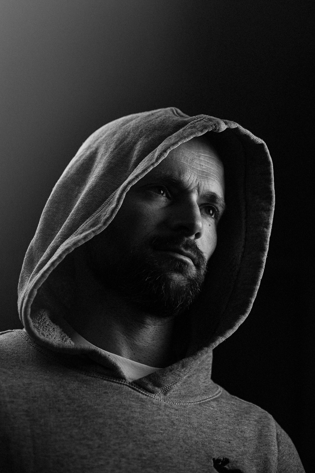 Schwarz-Weiß-Portrait eines Mannes mit Kapuze