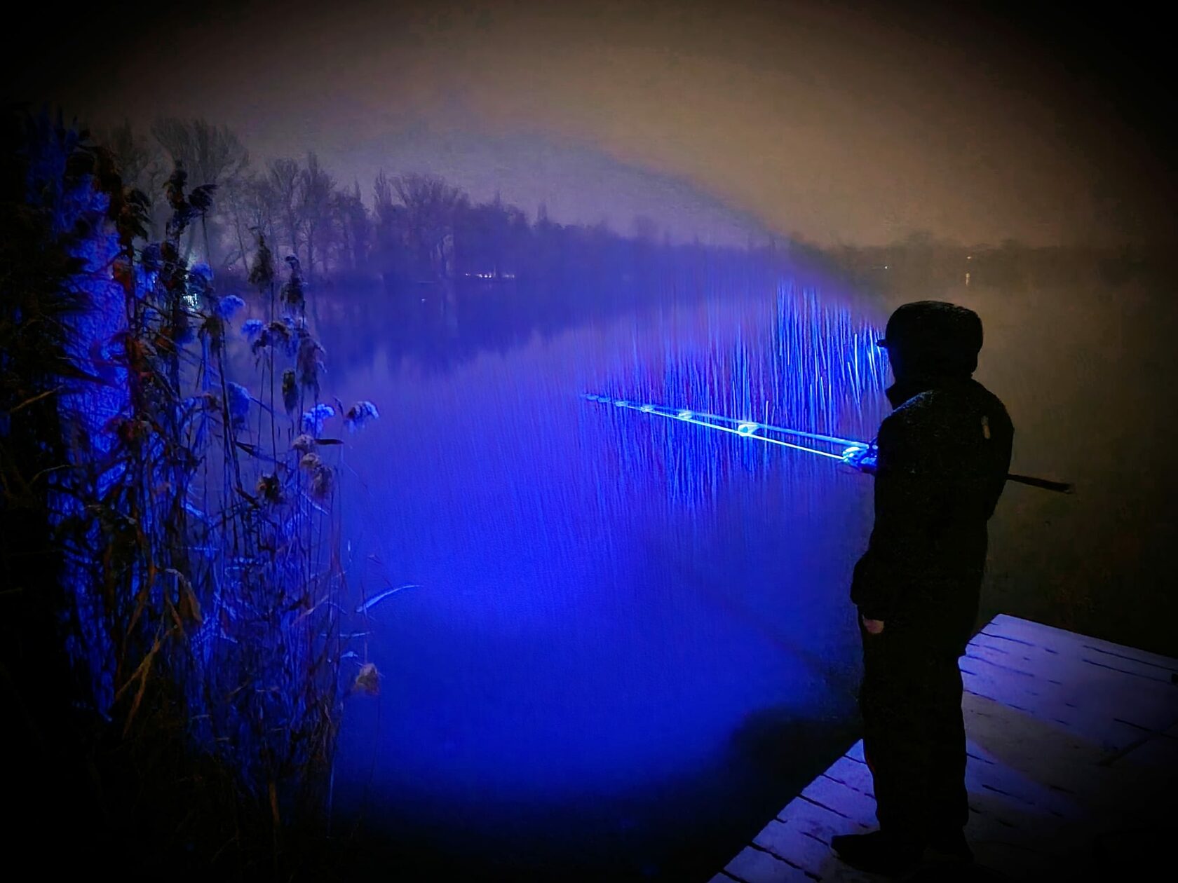 Angler using the Katran W/B 460 PRO headlamp