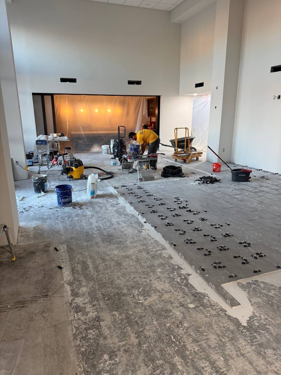 Large-format porcelain tile installation with leveling system in a commercial space