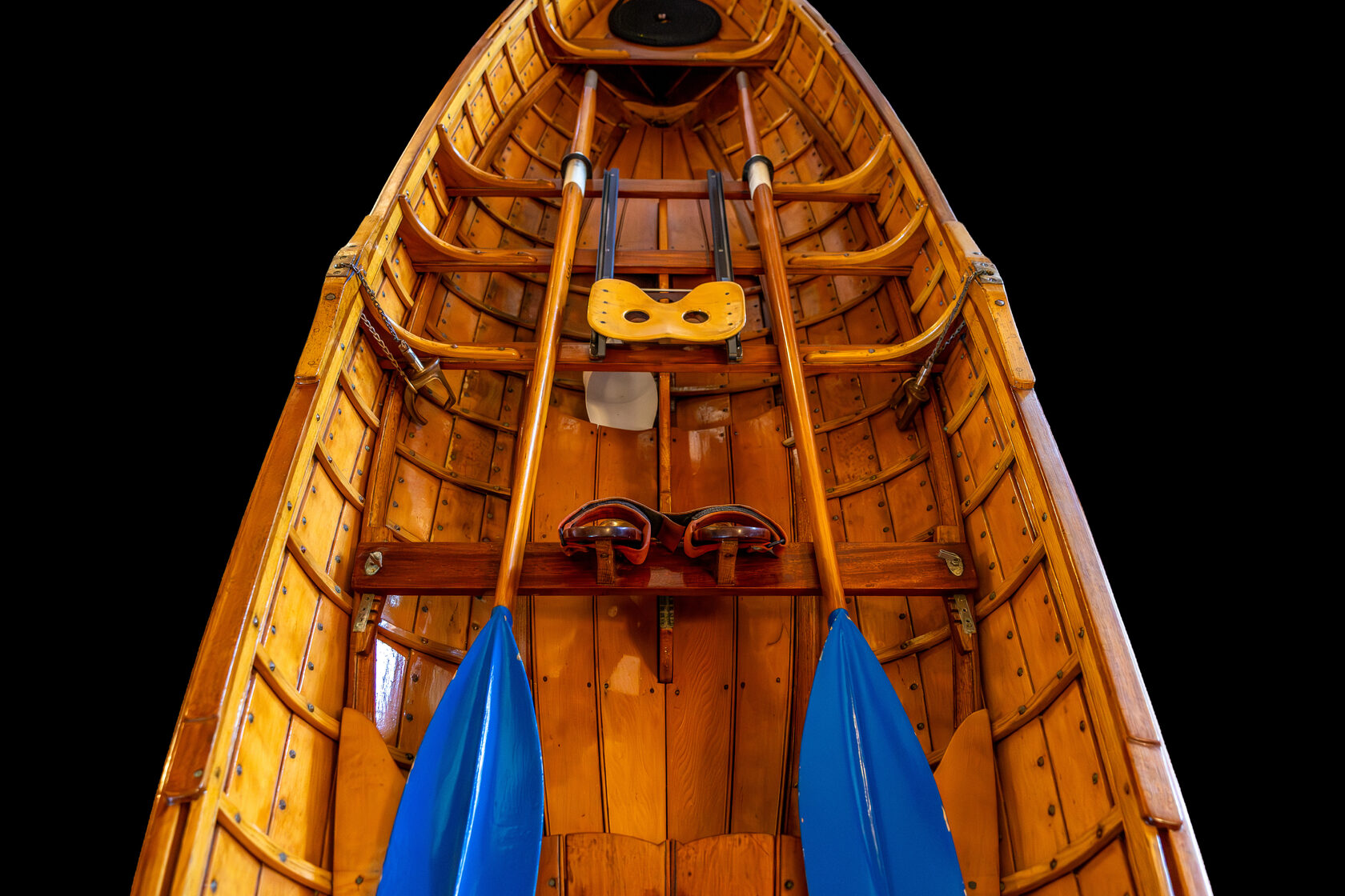 Overhead view of wooden rowing shell interior