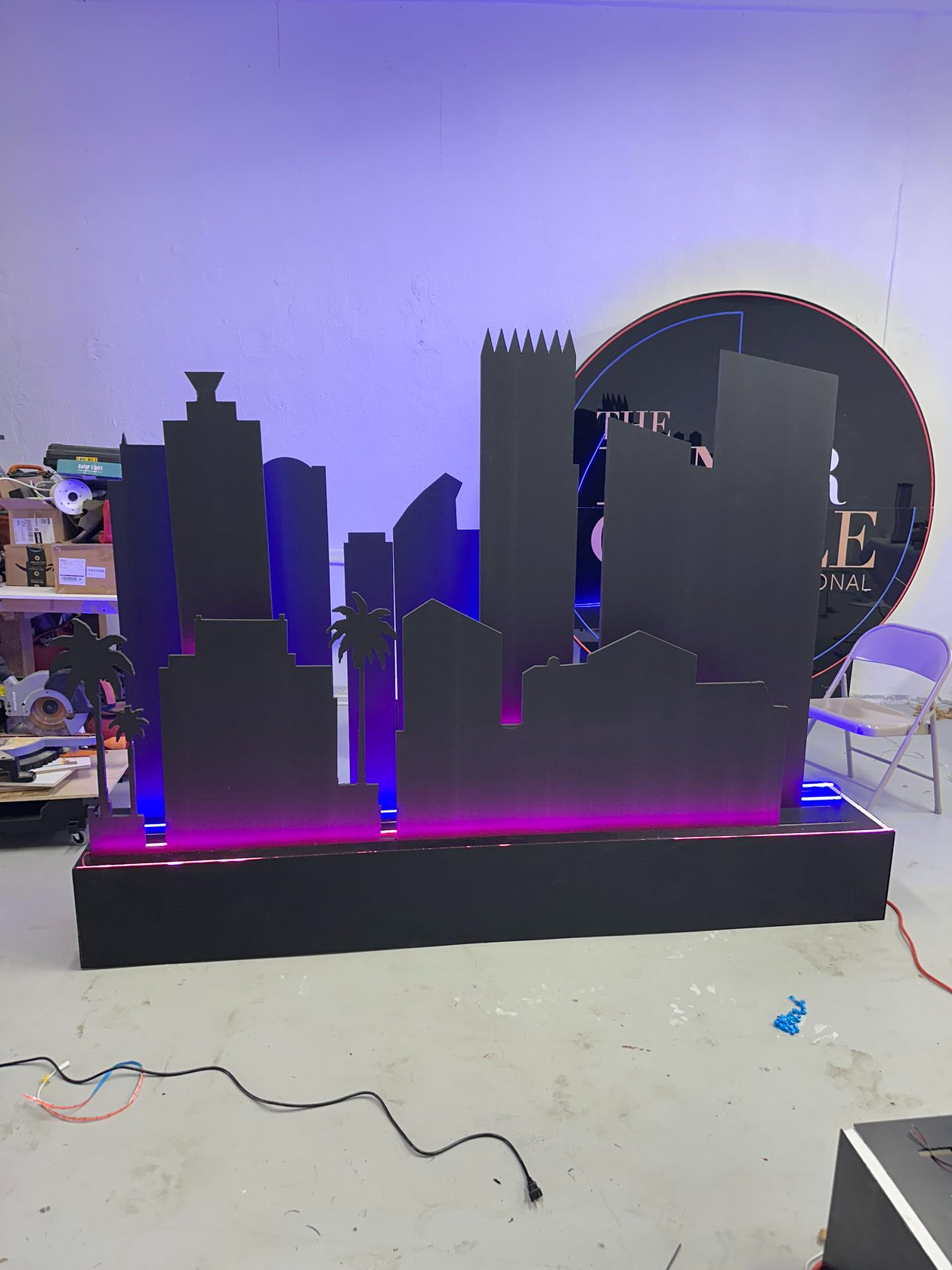 Layered Miami skyline scenery with LED lighting during fabrication in the Bart Creative Studio workshop