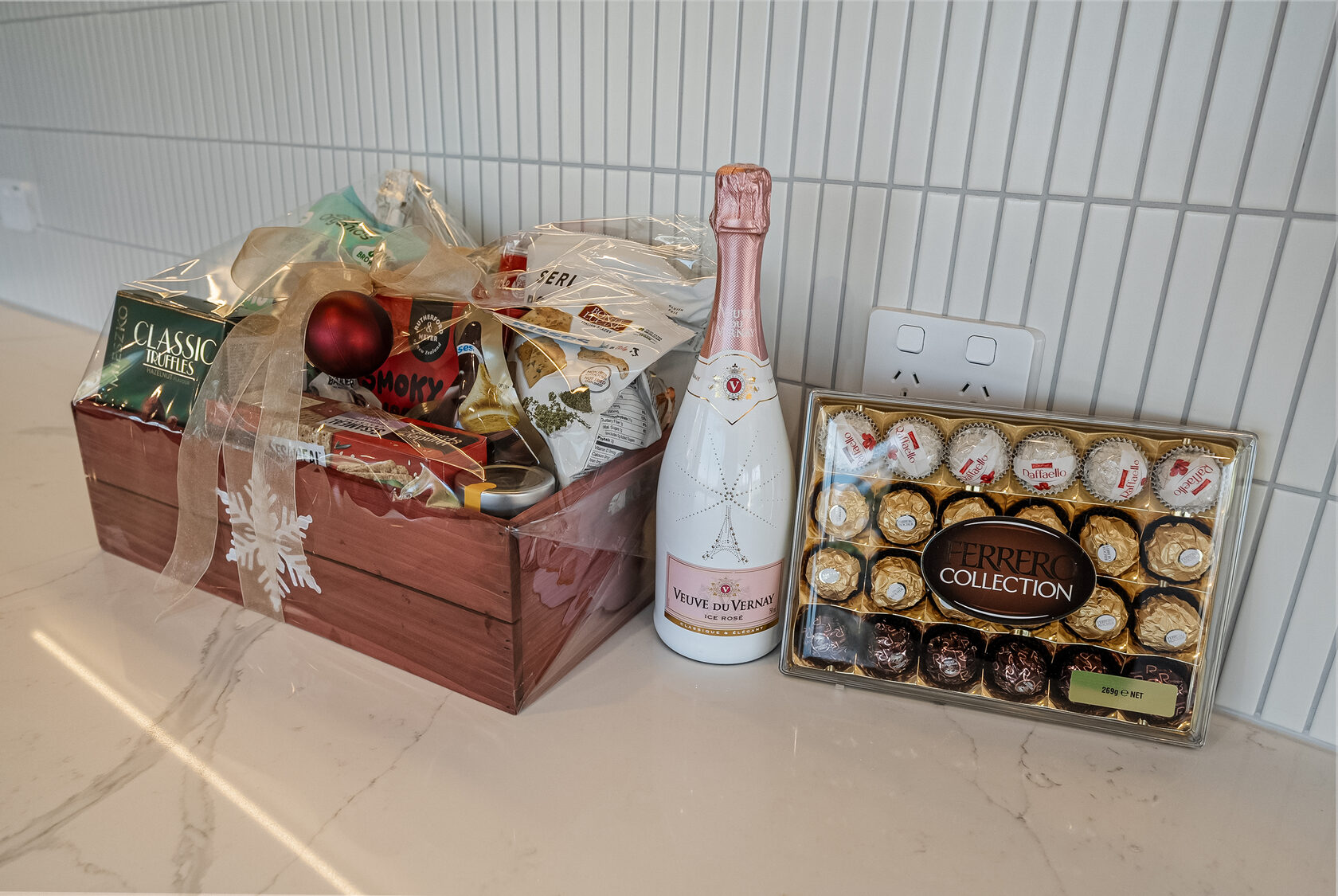Gift hamper arranged on the pale benchtop of the completed Glenfield kitchen