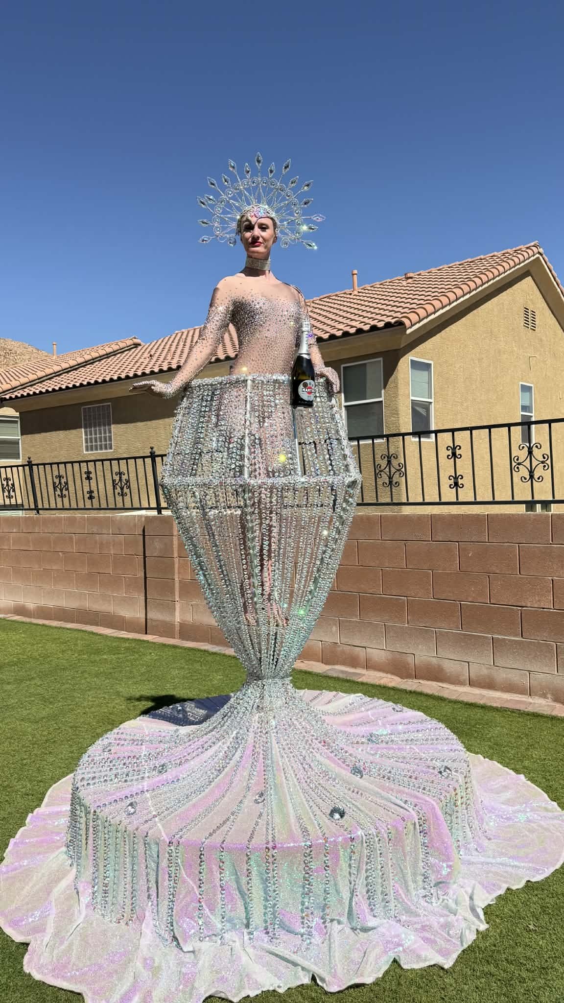 Diamond Girl serving champagne from the crystal glass prop