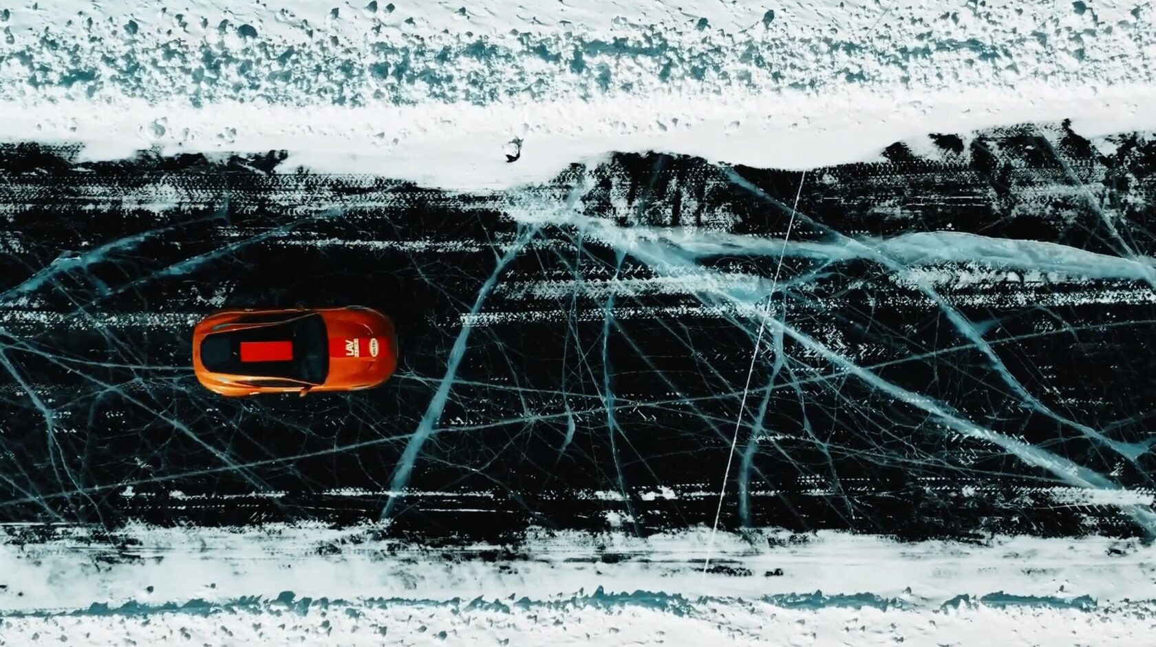 Jaguar drifting on cracked ice, top-down