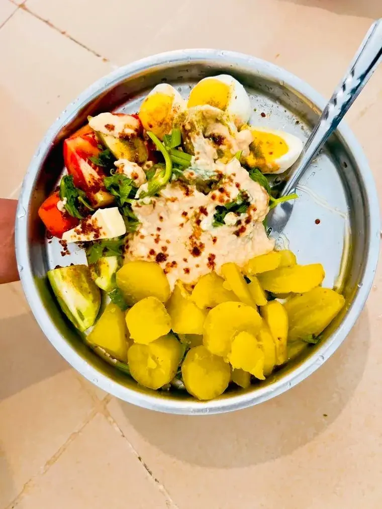 Breakfast with quail eggs, cherry tomatoes, hummus, herbs, and sweet potatoes at Vonfidel Ranch