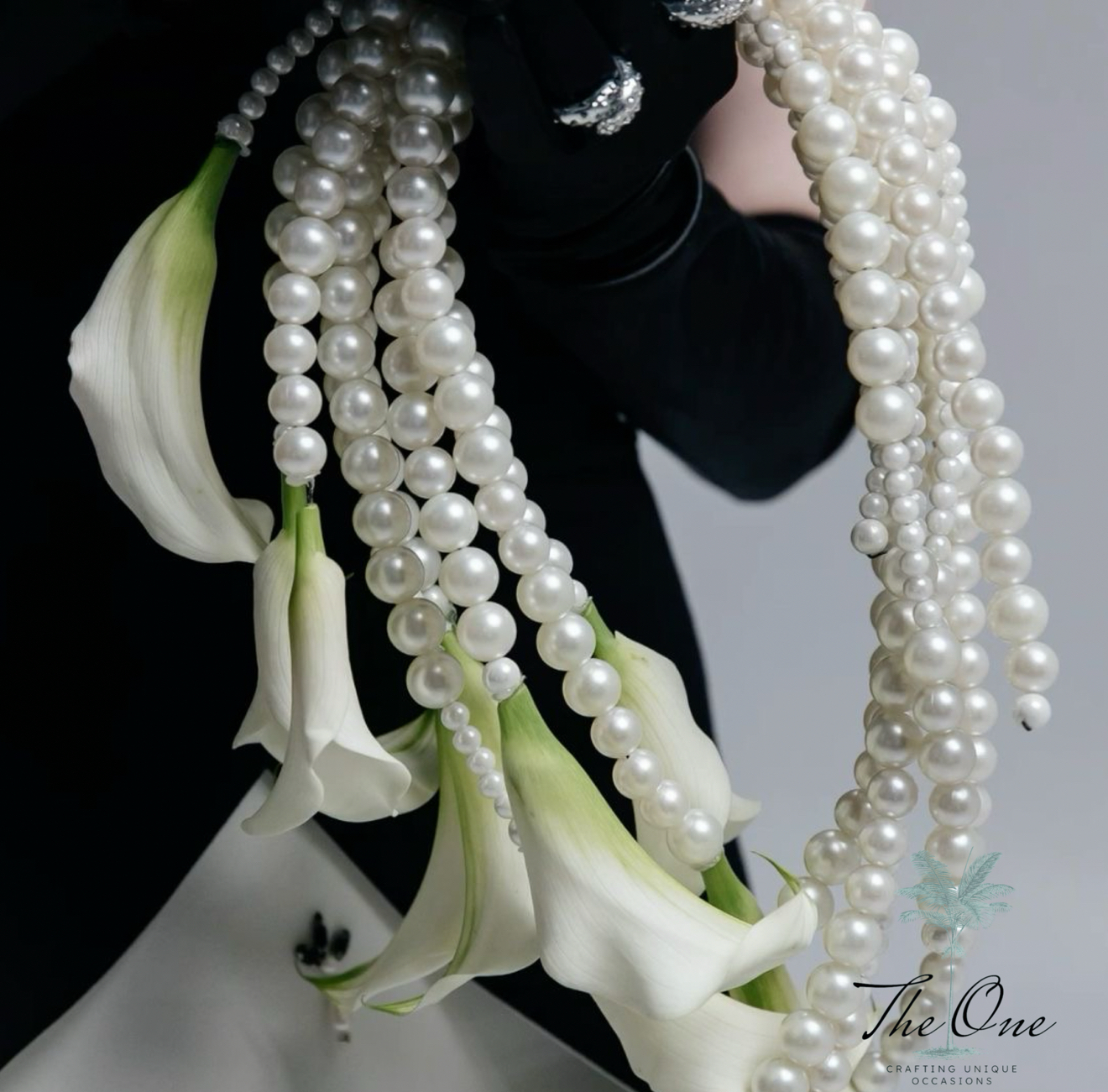 Elegant floral bridesmaids arrangement with pearls and lilies, ideal for weddings and special occasions in Miami.