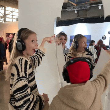 Children in headphones reacting to a sound installation