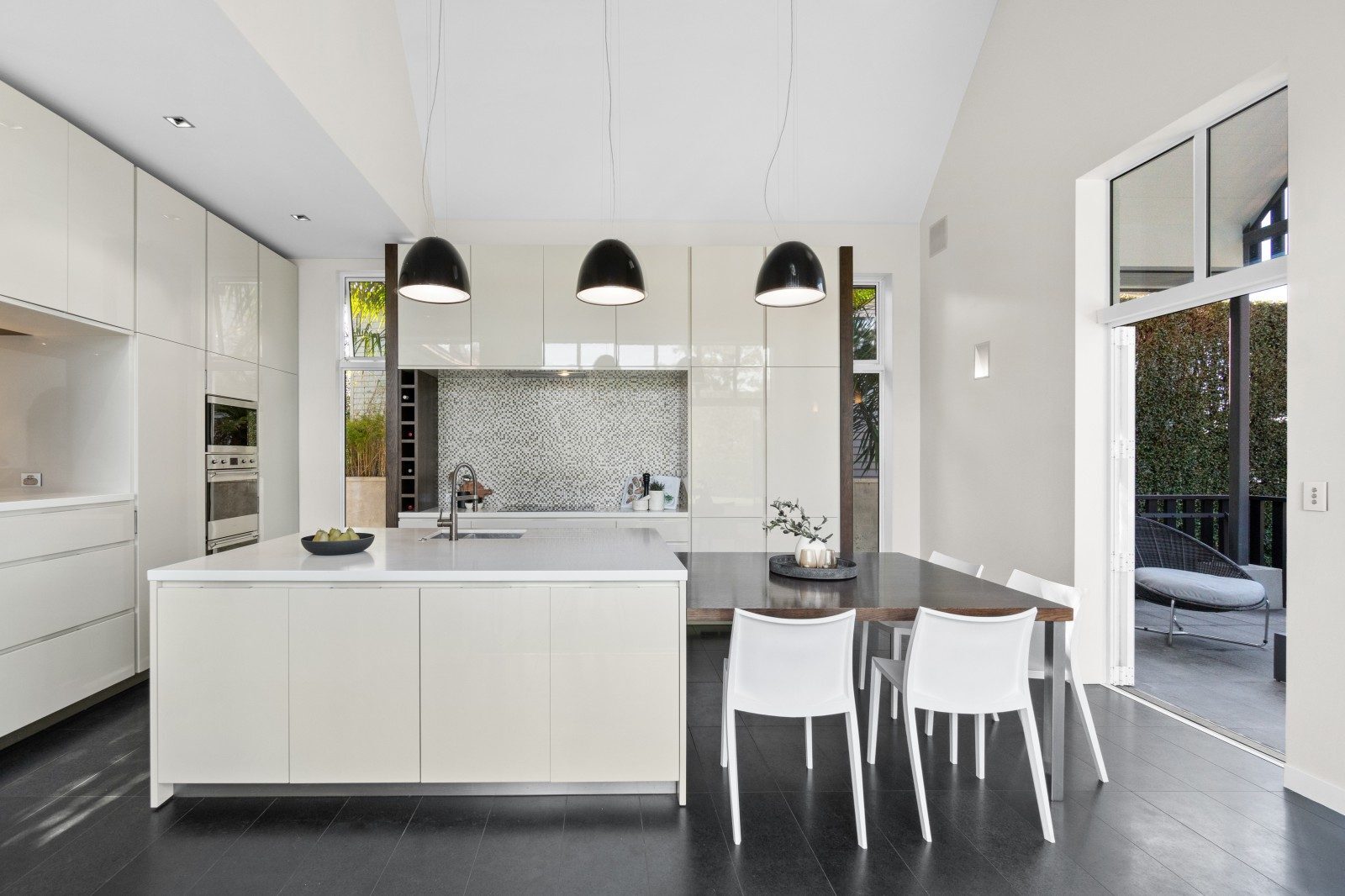 Owens Road Epsom kitchen with white cabinetry, a central island and pendant lighting