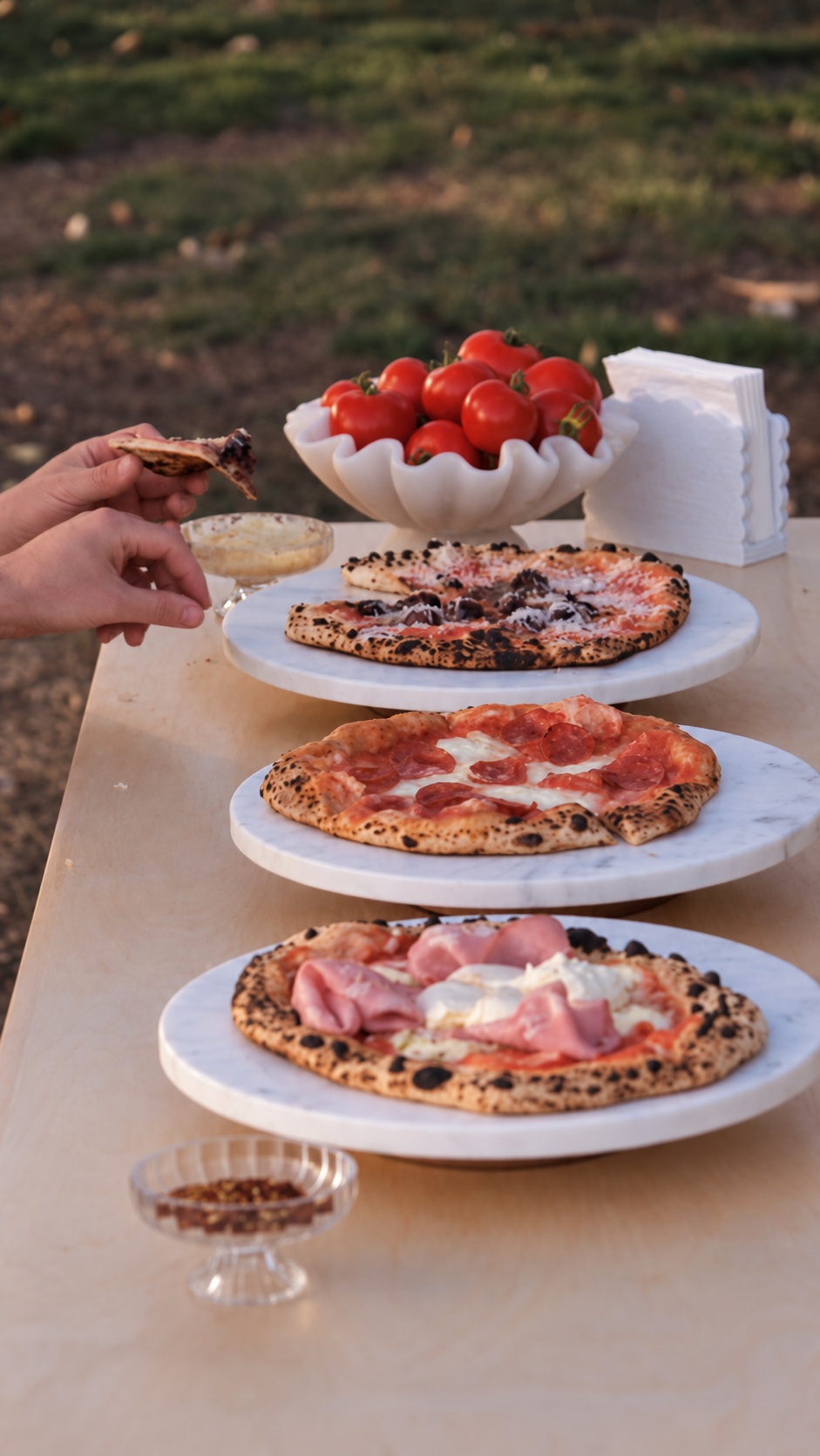 Saint Napoli pizzas on serving stands