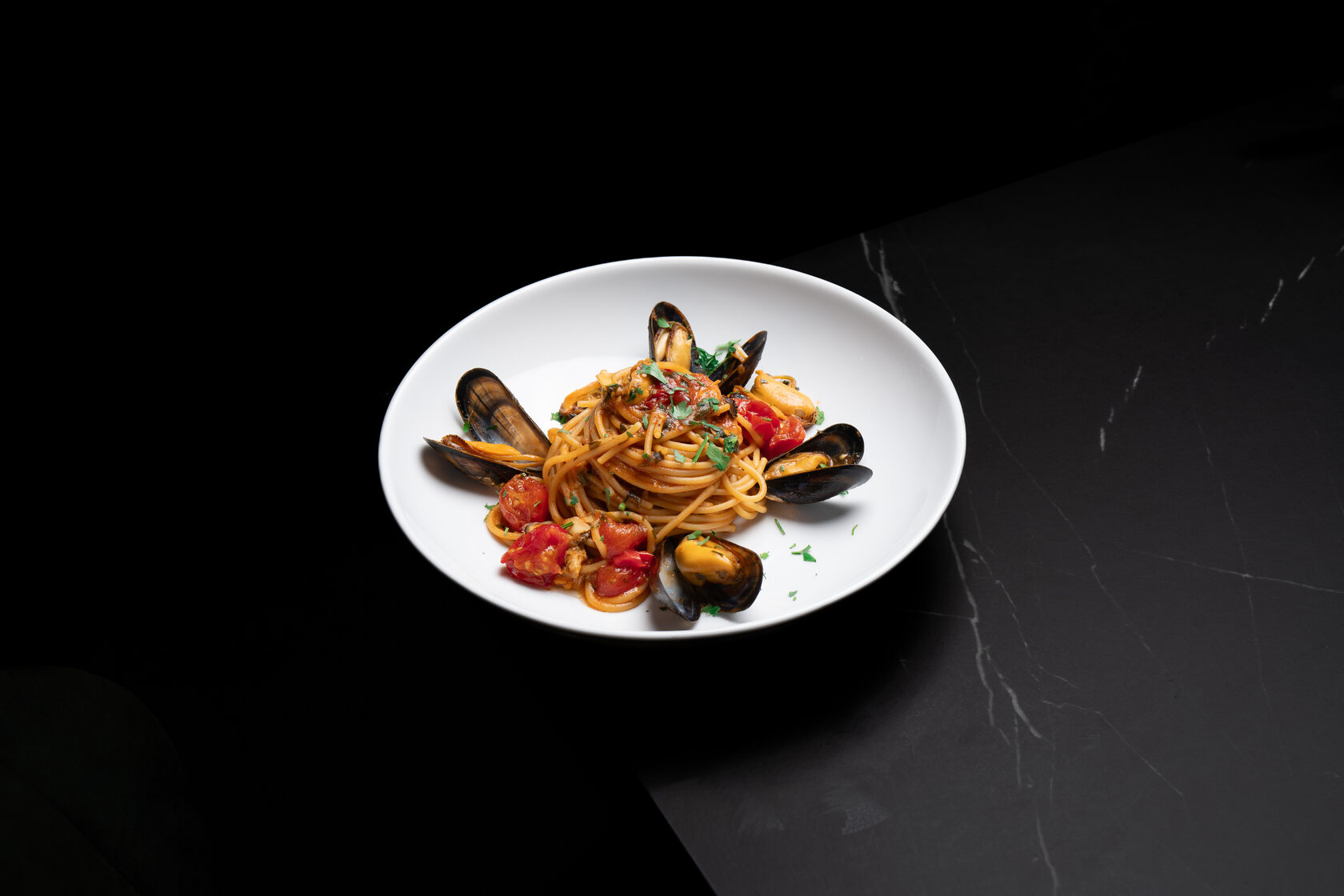 Plated restaurant food against a dark background
