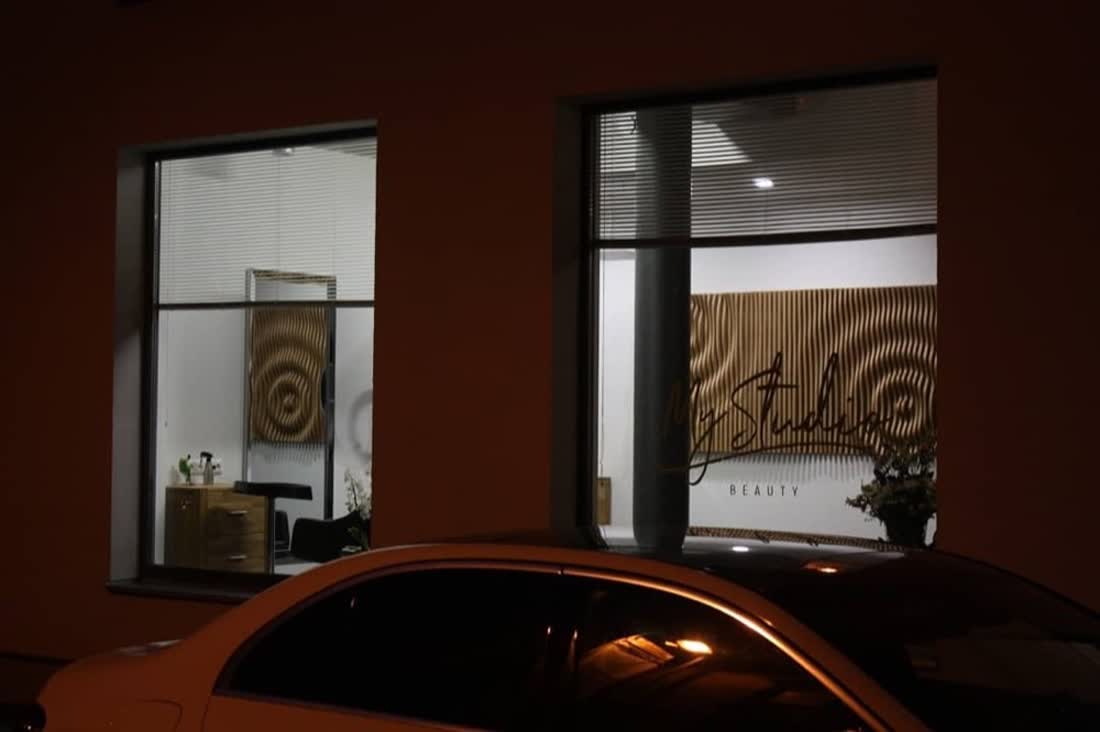 The salon at night from the street