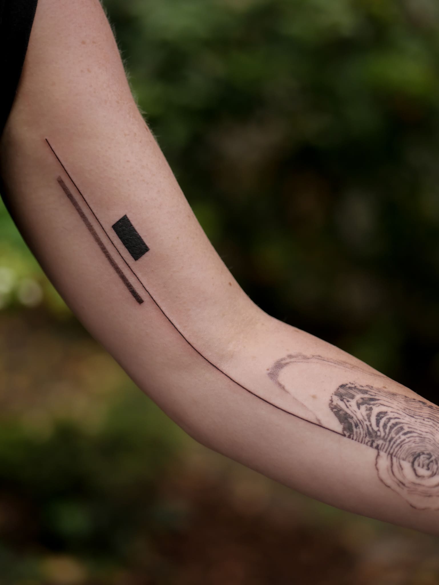 Fine lines and a black rectangle on the forearm