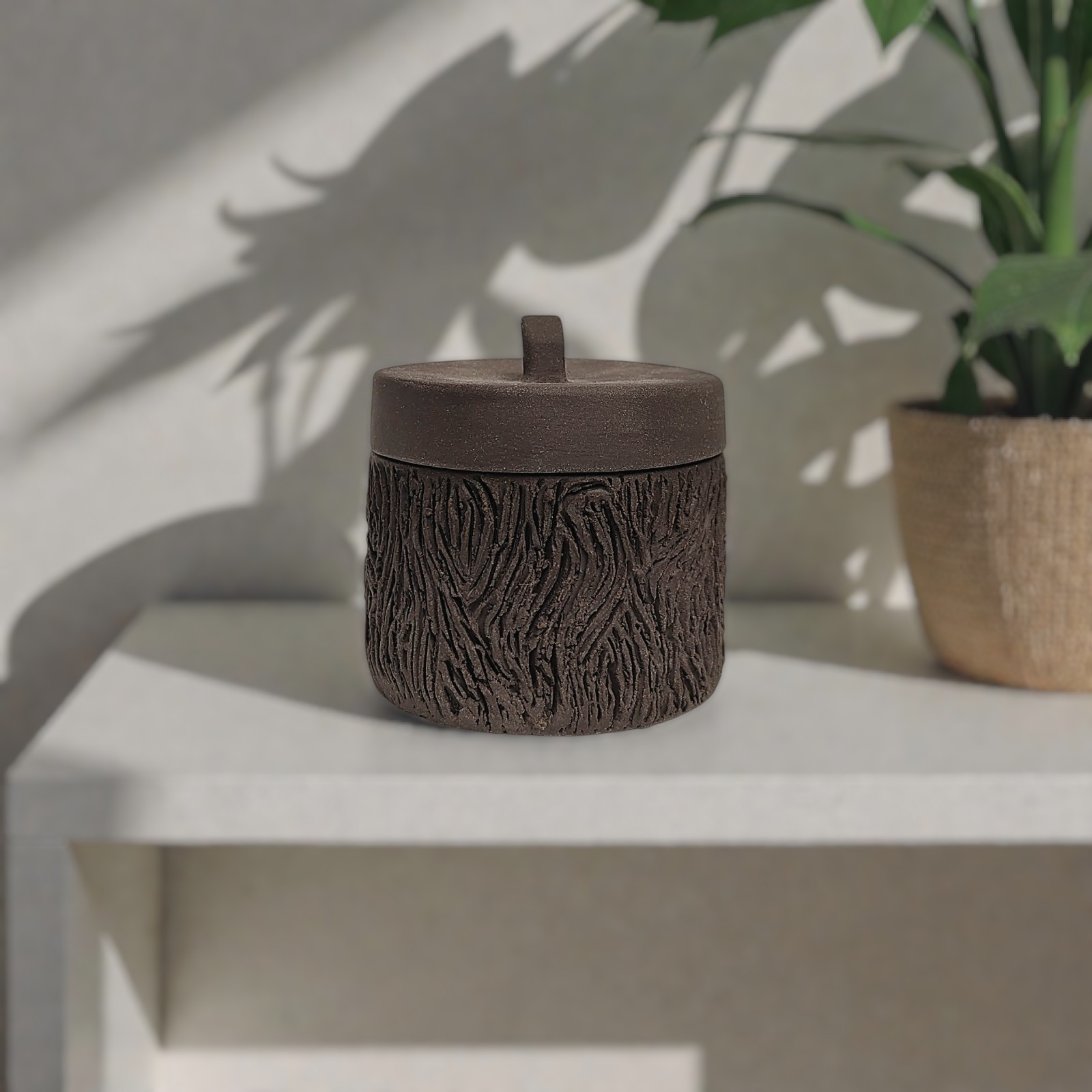 Handmade ceramic box with lid, dark brown wood-textured surface, artisan piece for small storage or home décor