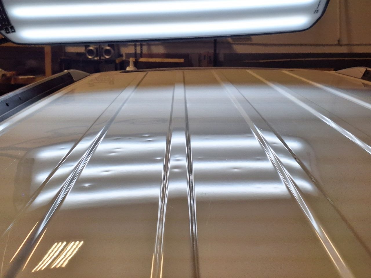 Vehicle roof with hail damage before repair