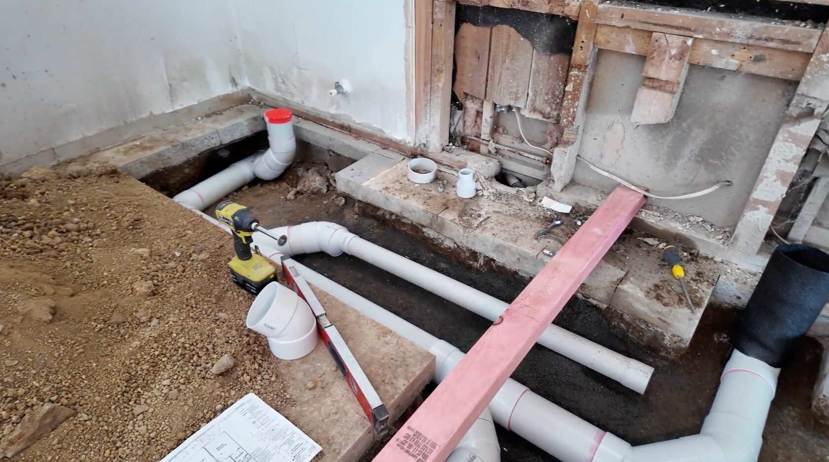 Exposed drainage pipes and excavated concrete floor during the Hillcrest renovation