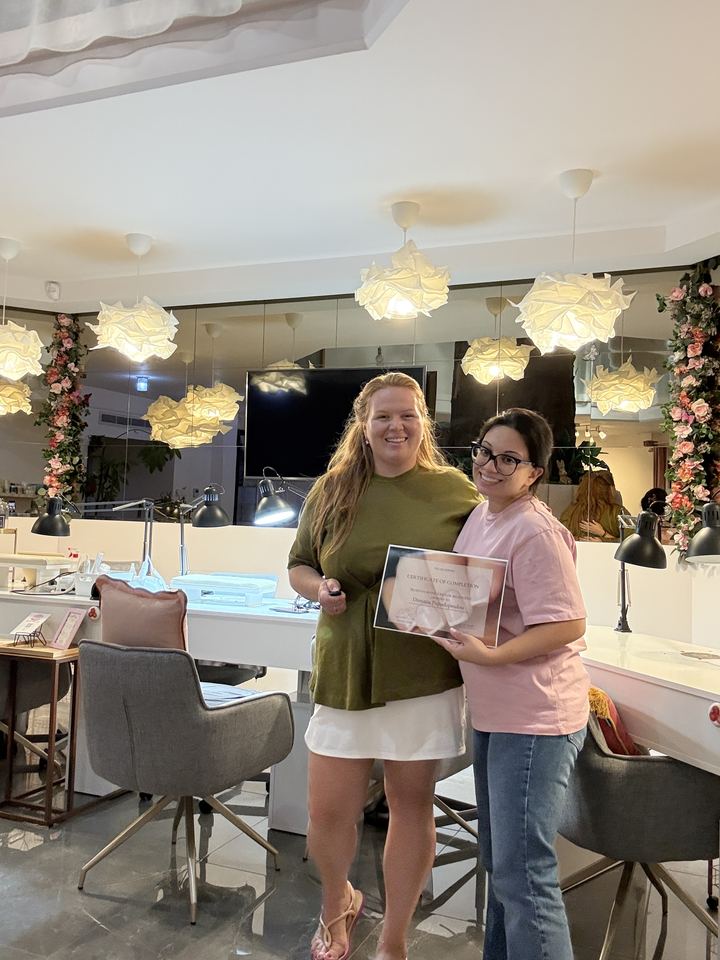 Graduate with her certificate and Nina in the practice room