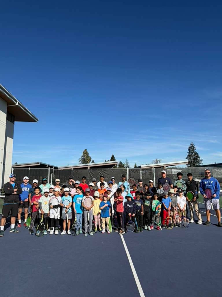 Kids in a group clinic on court