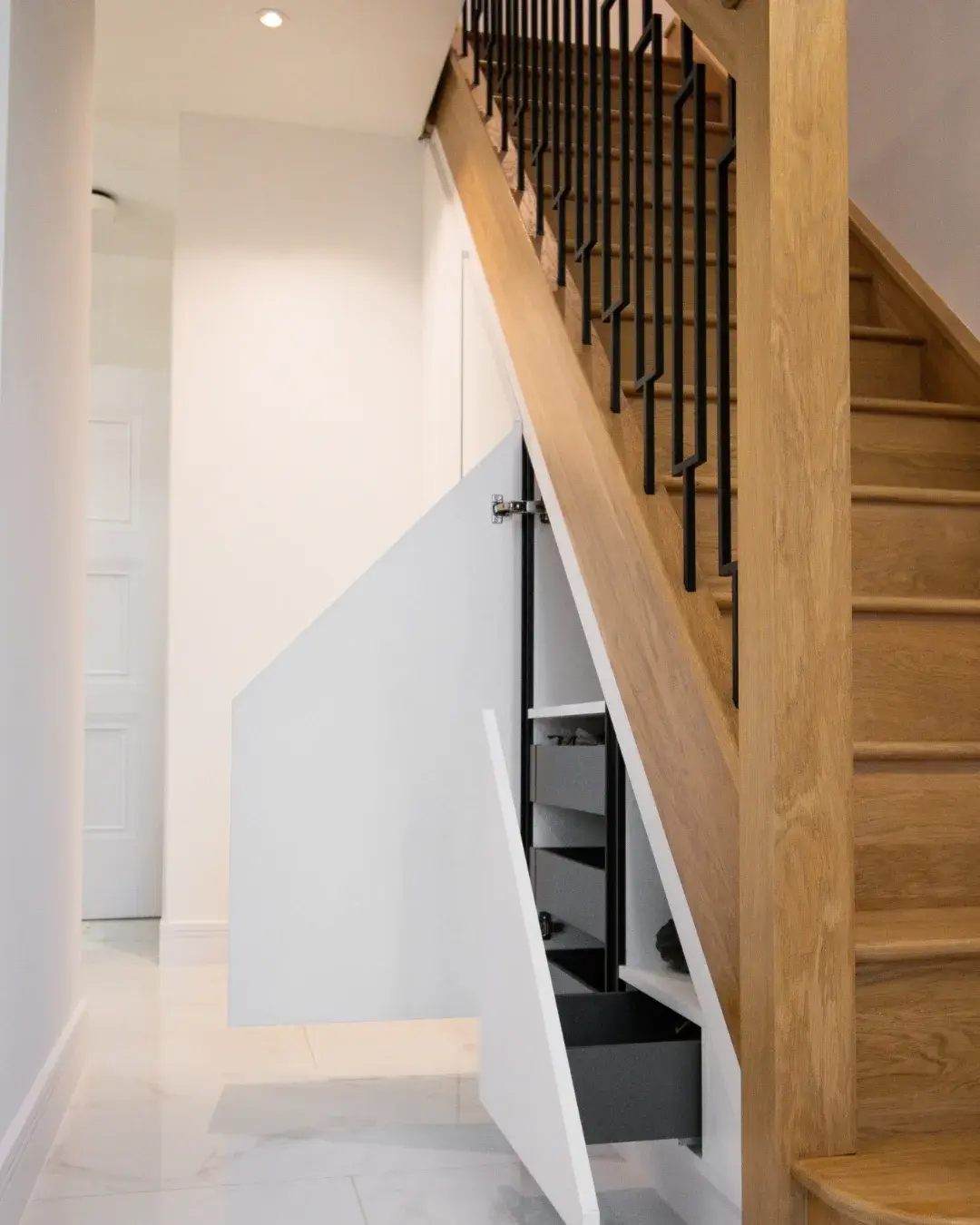 Custom under-stair storage with pull-out drawers