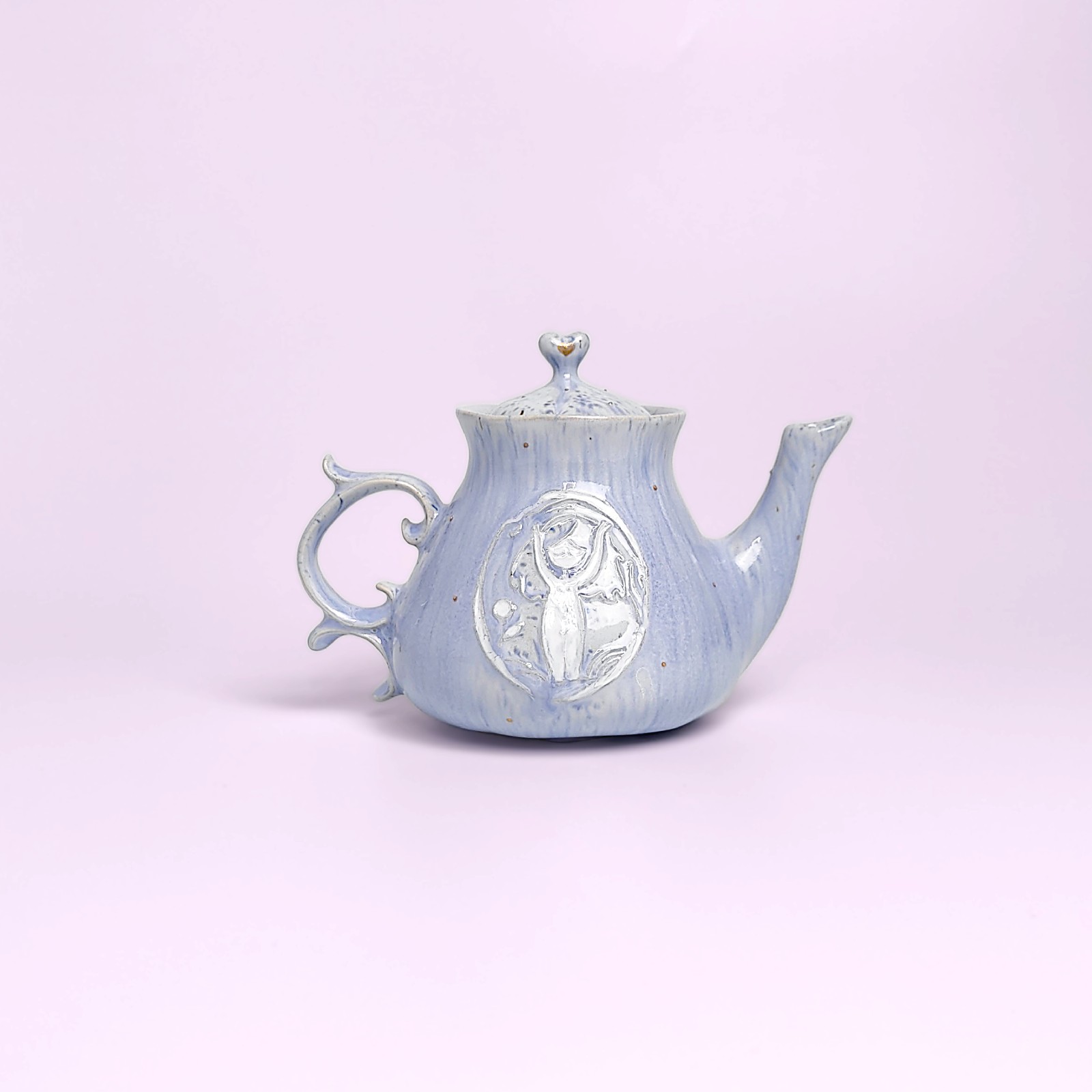 delicate blue handmade tea set — teapot, cups and saucers with carved forest fairy medallions