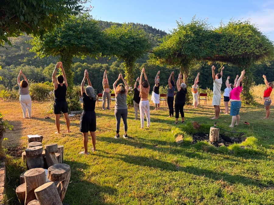 Practicing together at Monte da Orada, arms raised to the morning sky
