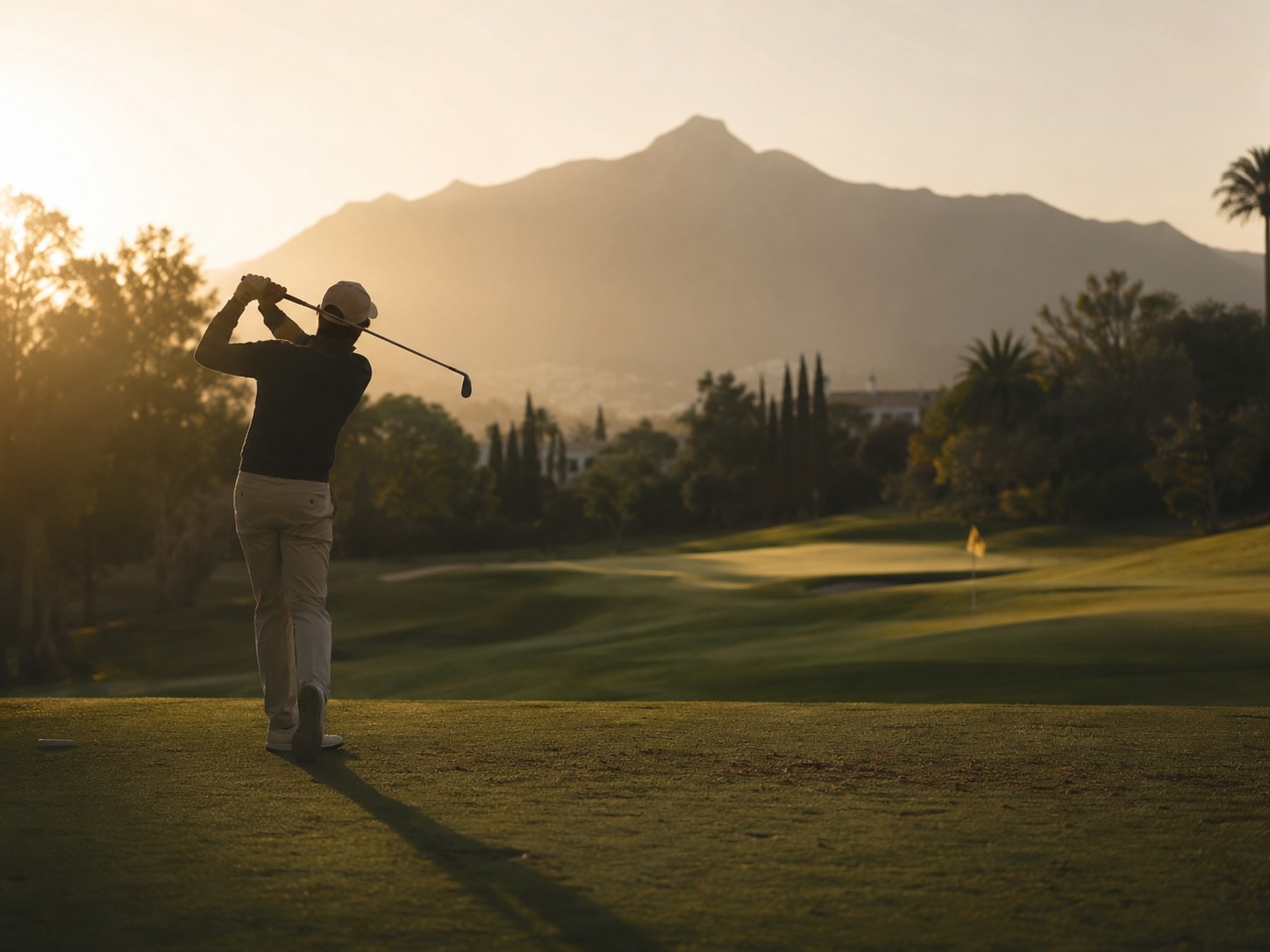 Golfer at sunrise on a fairway in the Golf Valley, Nueva Andalucía