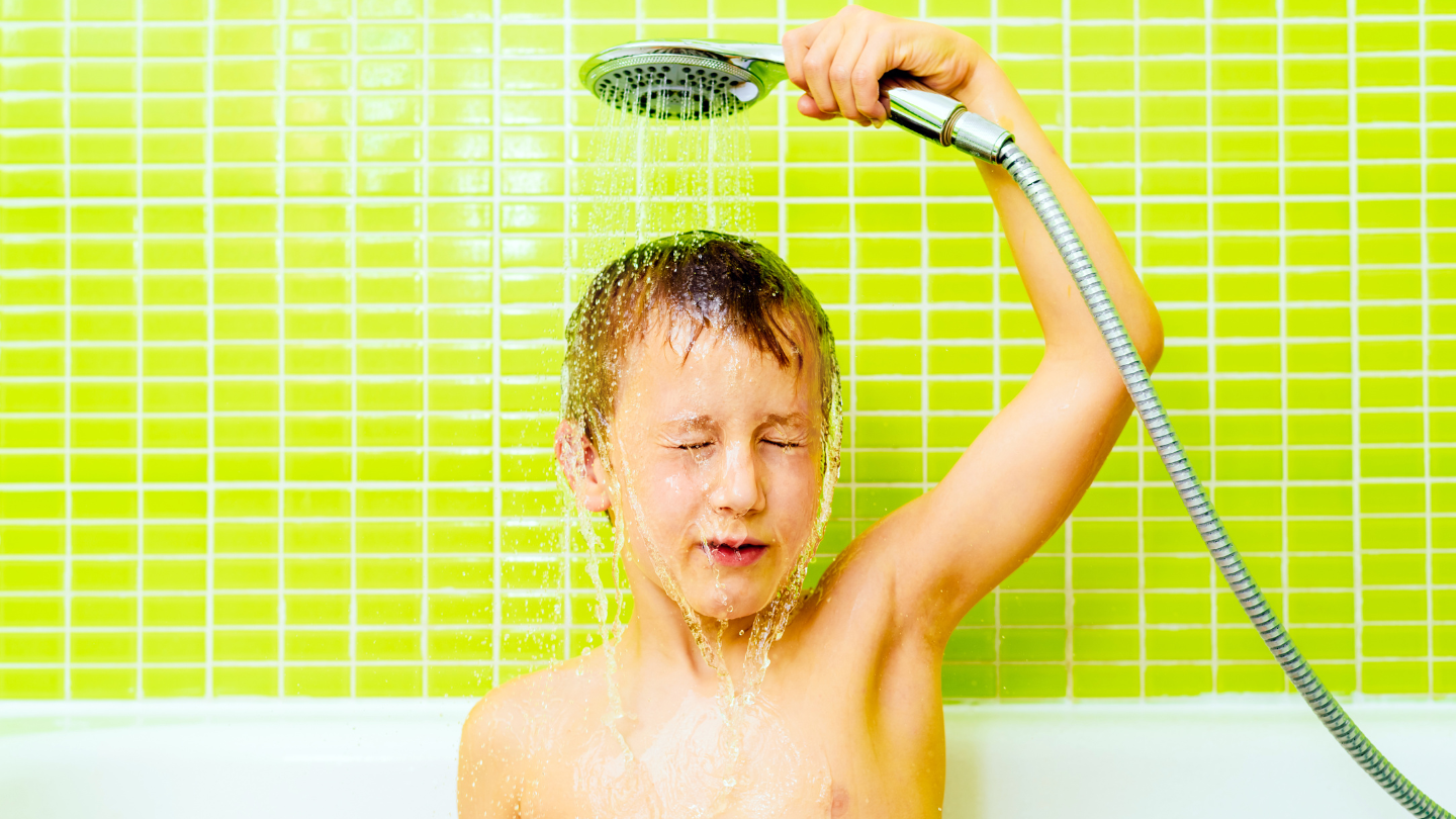 The image shows a child showering, illustrating how hard water affects skin and hair, causing dryness and irritation, and the importance of using water softeners for protection