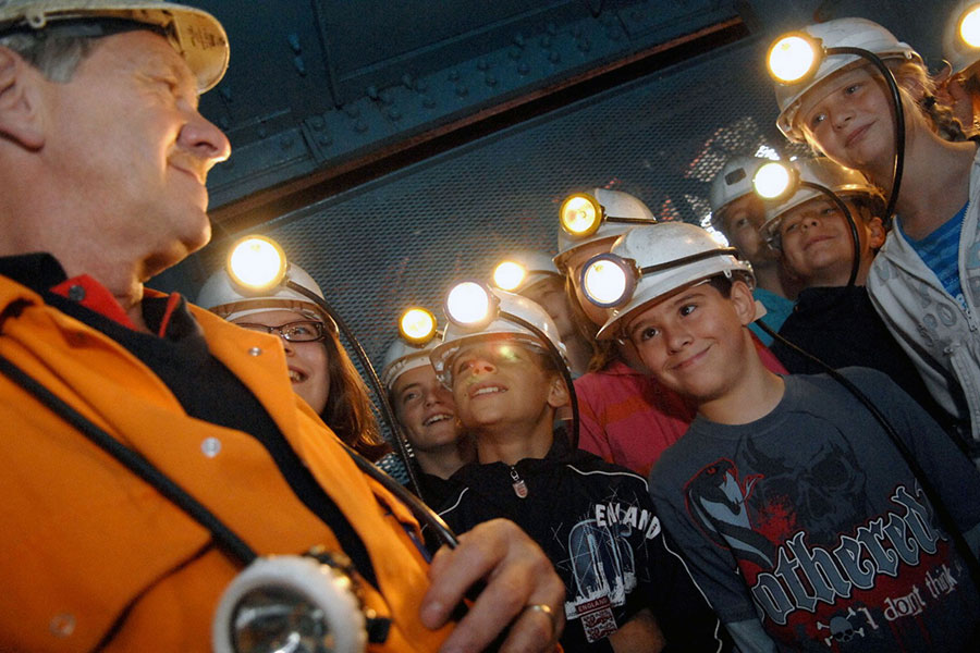 People with helmets at Big Pit mining museum